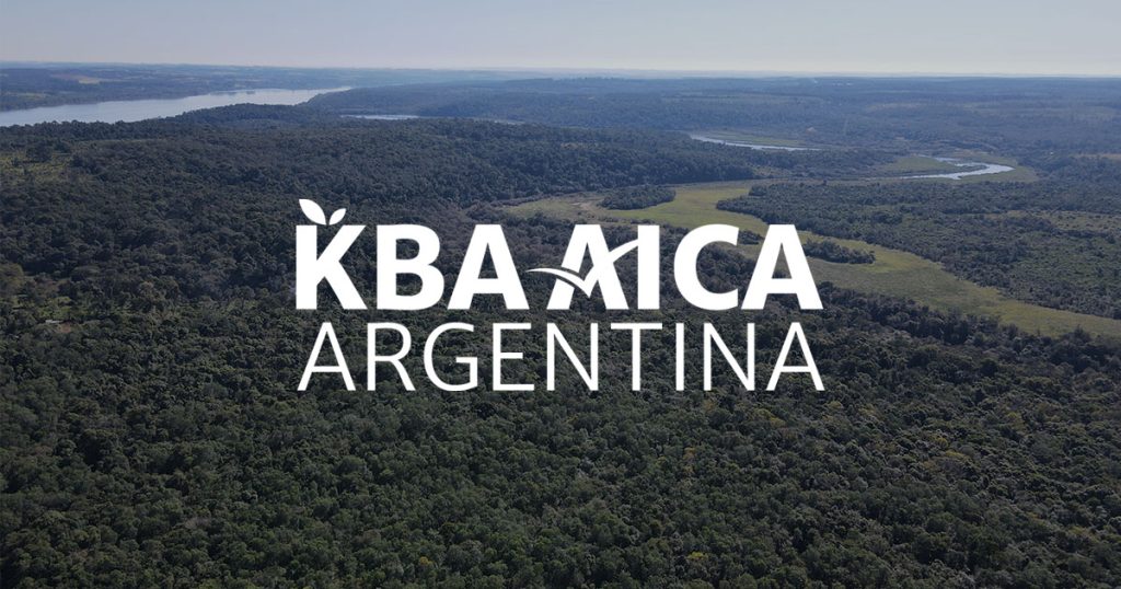 Logotipo de KBA AICA Argentina sobre un fondo fotográfico de un paisaje de la KBA Corpus.